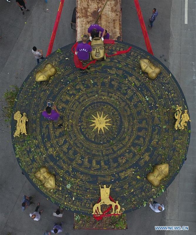 Photo taken on June 12, 2018 shows a giant bronze drum in Huanjiang Maonan Autonomous County, south China\'s Guangxi Zhuang Autonomous Region. The diameter of the drum is over six meters. It will be conveyed to Huazhumao plaza in Huanjiang. (Xinhua/Gao Dongfeng)