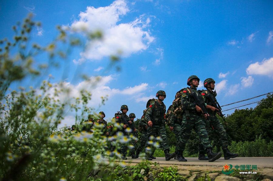 A group of soldiers march along a country road during the week-long rigorous training starting from June 11, 2018.  (Photo/81.cn)