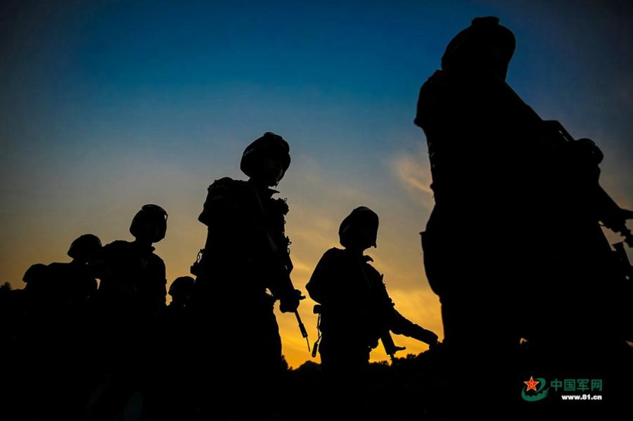 A group of soldiers march along a road during the week-long rigorous training starting from June 11, 2018. (Photo/81.cn)