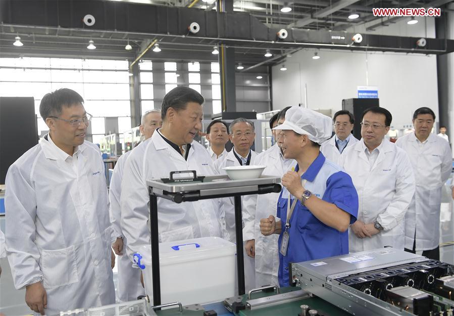 Chinese President Xi Jinping, also general secretary of the Communist Party of China (CPC) Central Committee and chairman of the Central Military Commission, visits a high-end fault tolerant computer production base of the Inspur Group in the high-tech zone of Jinan, capital of east China\'s Shandong Province, June 14, 2018. Xi made an inspection tour in Shandong from June 12 to 14. (Xinhua/Li Xueren)