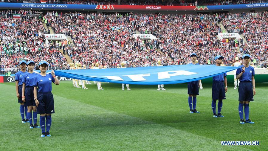 Chinese caddies enter into the field holding a FIFA flag before the opening match of the 2018 FIFA World Cup in Moscow, Russia, on June 14, 2018. (Xinhua/Yang Lei)