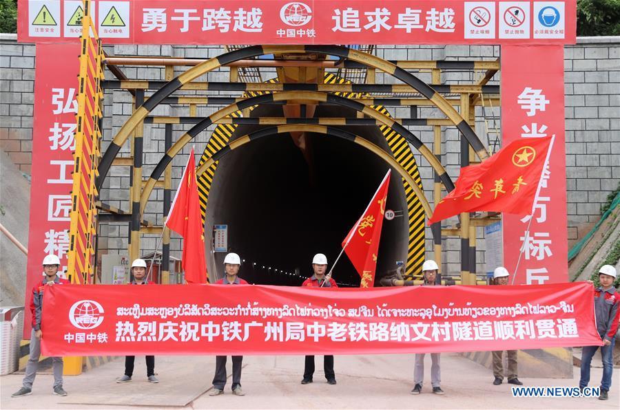 Workers celebrate the breakthrough of the second tunnel of the China-Laos railway in Laos\' northern town of Muangxay, Oudomxay Province, on June 12, 2018. The China Railway Guangzhou Engineering Group (CREC Guangzhou) has broken through the Ban Naven Tunnel of the China-Laos railway, securing steady progress in the construction of the railway project. (Xinhua/Liang Wendong)