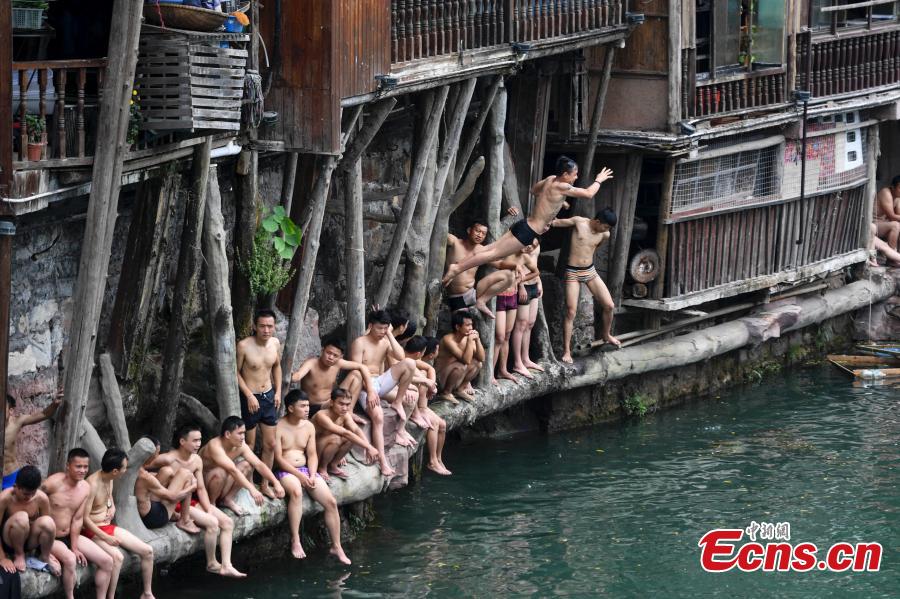 Participants compete to grab ducks during a folk event to celebrate the Dragon Boat Festival in the Tuojiang River in Phoenix Ancient Town, Central China’s Hunan Province, June 18, 2018. The duck-chasing tradition in the river has a 100-year history. (Photo: China News Service/Yang Huafeng)