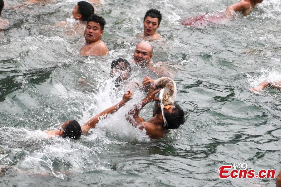 Participants compete to grab ducks during a folk event to celebrate the Dragon Boat Festival in the Tuojiang River in Phoenix Ancient Town, Central China’s Hunan Province, June 18, 2018. The duck-chasing tradition in the river has a 100-year history. (Photo: China News Service/Yang Huafeng)