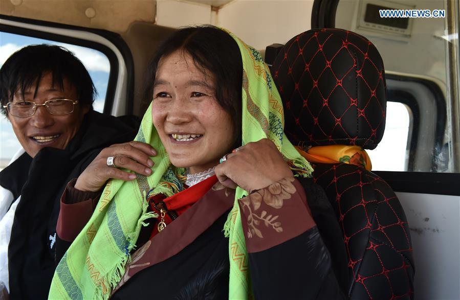 Villagers sit in a coach which will carry them from Nyima County of Nagqu to a new settlement in Lhasa during a relocation program with environmental purposes, southwest China\'s Tibet Autonomous Region, June 17, 2018. A total of 1,102 residents have been relocated to a new settlement in Lhasa to make their old neighbourhoods accessible to wild animals in the Qiangtang National Nature Reserve. Completed on Monday, the relocation marked the first such program carried out for the sake of environmental protection in areas at high altitudes in Tibet Autonomous Region. (Xinhua/Chogo)
