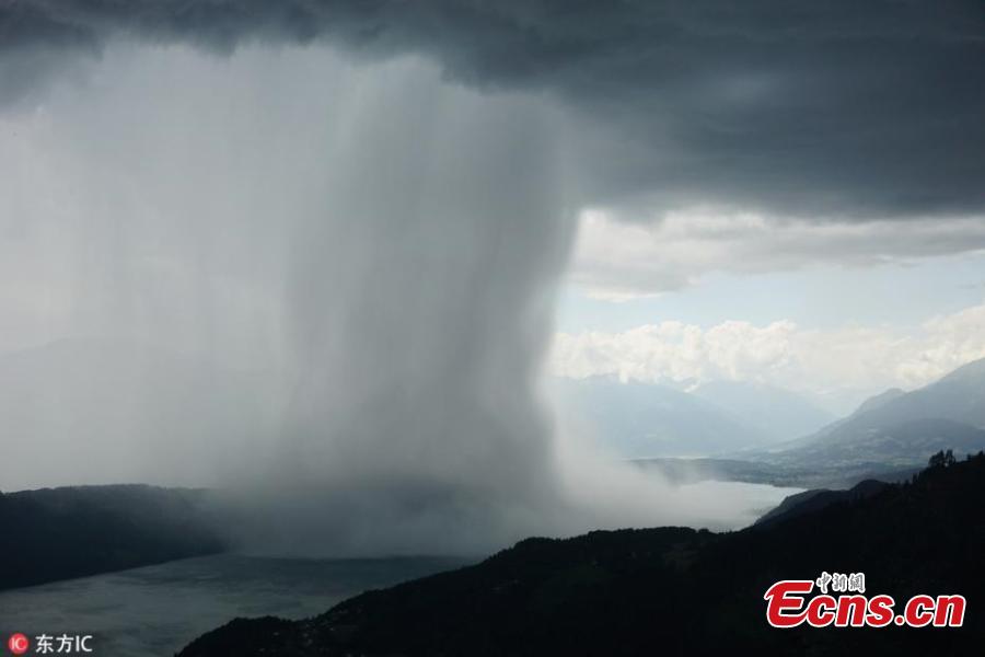 Image from a video taken by amateur filmmaker Peter Maier shows the incredible moment a storm is caught suddenly dumping tons of water, a weather phenomenon known as a wet microburst, while staying at Lake Millstatt in Austria. The 27 year old described the storm as being like a \'tsunami from heaven\'.(Photo/IC)