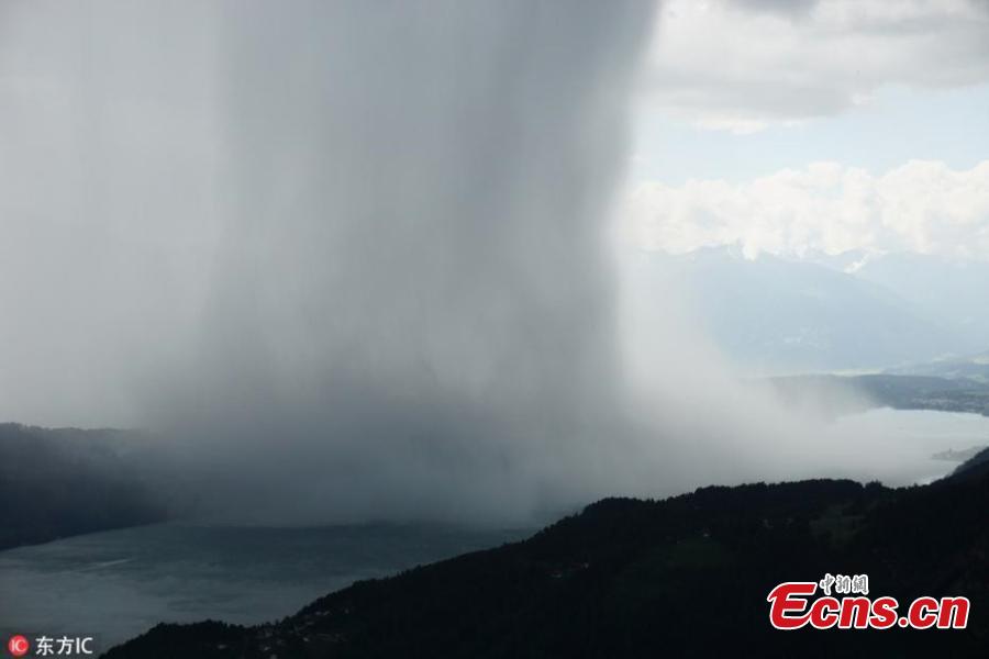 Image from a video taken by amateur filmmaker Peter Maier shows the incredible moment a storm is caught suddenly dumping tons of water, a weather phenomenon known as a wet microburst, while staying at Lake Millstatt in Austria. The 27 year old described the storm as being like a \'tsunami from heaven\'.(Photo/IC)