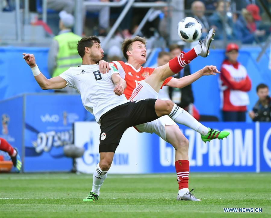 Aleksandr Golovin (R) of Russia vies with Tarek Hamed of Egypt during a Group A match between Russia and Egypt at the 2018 FIFA World Cup in Saint Petersburg, Russia, June 19, 2018. (Xinhua/Li Ga)