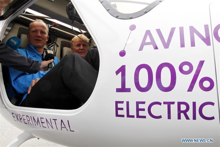 Norwegian airport operator Avinor\'s CEO Dag Falk-Petersen (R) and Minister of Transport and Communications Ketil Solvik-Olsen recieve interview while sitting in the two-seat electric aircraft, Alpha Electro G2, at the airport in Oslo, Norway, June 18, 2018. Norway\'s first electric aircraft took to the skies on Monday as the Nordic country that is known for electric cars vowed to electrify its aviation as well. (Xinhua/Liang Youchang)
