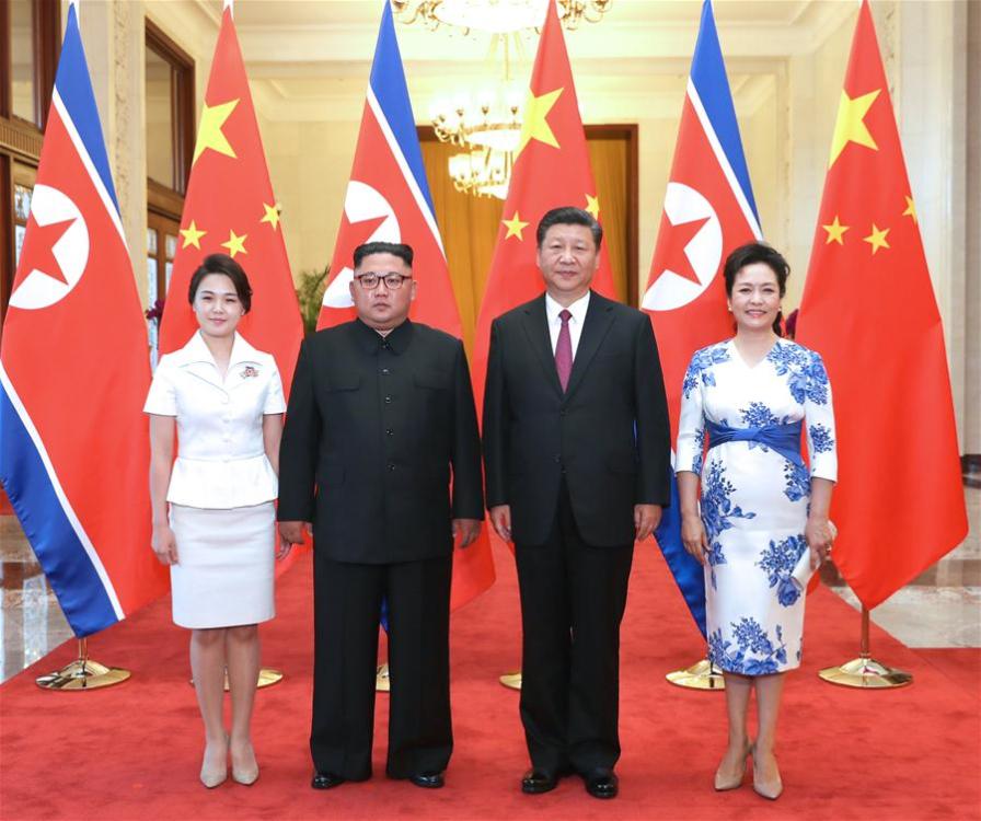 Xi Jinping (2nd R), general secretary of the Central Committee of the Communist Party of China (CPC) and Chinese president, and his wife Peng Liyuan (1st R) pose for photos with Kim Jong Un (2nd L), chairman of the Workers\' Party of Korea and chairman of the State Affairs Commission of the Democratic People\'s Republic of Korea (DPRK), and his wife Ri Sol Ju at the Great Hall of the People in Beijing, capital of China, June 19, 2018. Xi Jinping held talks with Kim Jong Un here on Tuesday. (Xinhua/Ju Peng)