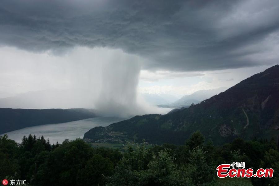 Image from a video taken by amateur filmmaker Peter Maier shows the incredible moment a storm is caught suddenly dumping tons of water, a weather phenomenon known as a wet microburst, while staying at Lake Millstatt in Austria. The 27 year old described the storm as being like a \'tsunami from heaven\'.(Photo/IC)