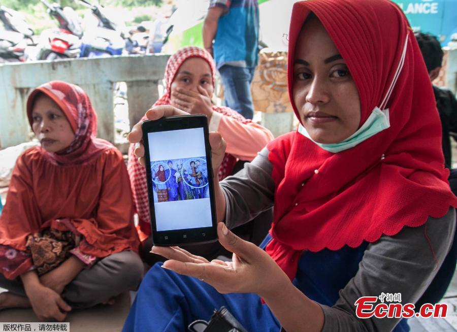 Family members sit together as they wait for rescue teams searching for missing passengers at the Lake Toba ferry port in the province of North Sumatra on June 20, 2018, after a boat capsized on June 18. The death toll from an Indonesian ferry disaster could top 180, as authorities raised an estimate of the number of people missing two days after the wooden tourist boat sank in Lake Toba on the island of Sumatra. (Photo/Agencies)