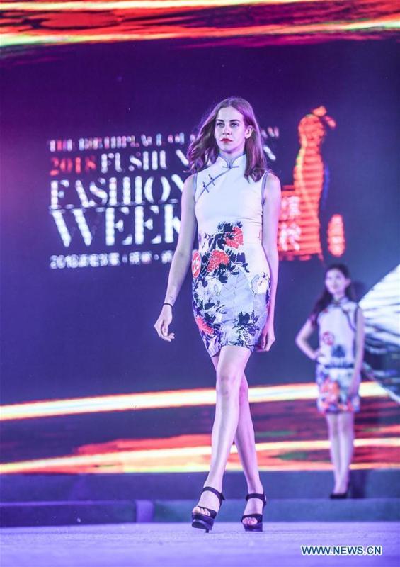 Models show cheongsam, traditional Chinese women\'s dress also known as Qipao, during the 1st international qipao model competition in Xinbin Manchu Autonomous County in Fushun City, northeast China\'s Liaoning Province, June 23, 2018. (Xinhua/Pan Yulong)