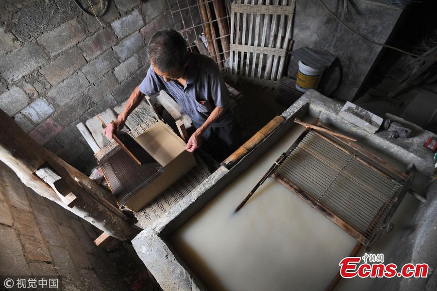 Huang Shiguo, 65, makes paper using ancient methods in his home in Baishui Village, Qiandongnan Miao and Dong Autonomous Prefecture, Southwest China’s Guizhou Province. Huang said he began learning the traditional paper-making craft at 29 and has been dedicated to the ancient craft ever since. Locals in the area have a more than 1,000-year history of paper making as the region is rich in Yangshan Bamboo, a main material needed for the craft. Huang said the typical process involves 72 steps and 55 days to produce paper. (Photo/VCG)