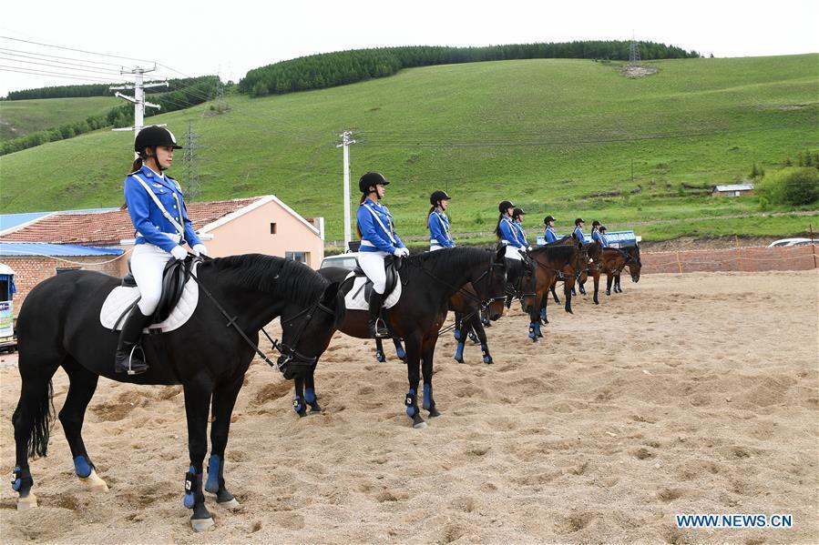 Members of a female mounted patrol unit gather on a training ground in Arxan, north China\'s Inner Mongolia Autonomous Region, June 24, 2018. Every year, the female mounted patrol unit of Arxan will patrol the city between June and October, the high season for tourism. Apart from regular patrols, the members are also expected to perform ceremonial tasks on formal occasions. (Xinhua/Liu Lei)