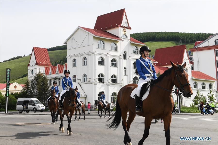 Members of a female mounted patrol unit are seen on duty in Arxan, north China\'s Inner Mongolia Autonomous Region, June 24, 2018. Every year, the female mounted patrol unit of Arxan will patrol the city between June and October, the high season for tourism. Apart from regular patrols, the members are also expected to perform ceremonial tasks on formal occasions. (Xinhua/Liu Lei)
