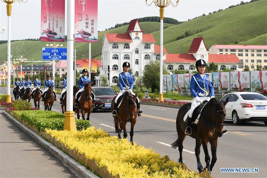 Members of a female mounted patrol unit are seen on duty in Arxan, north China\'s Inner Mongolia Autonomous Region, June 24, 2018. Every year, the female mounted patrol unit of Arxan will patrol the city between June and October, the high season for tourism. Apart from regular patrols, the members are also expected to perform ceremonial tasks on formal occasions. (Xinhua/Liu Lei)