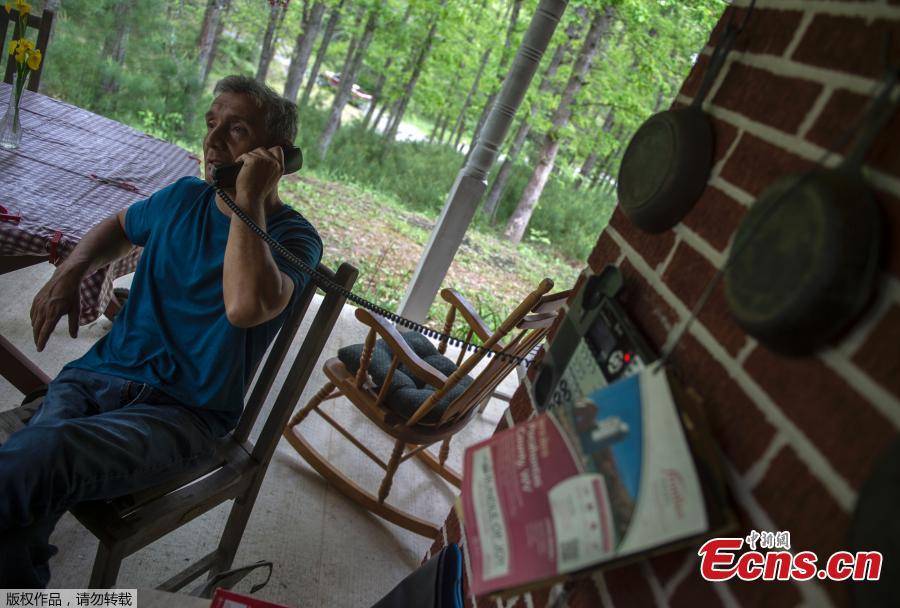 Carlos Sosa speaks on a wired phone in Green Bank, West Virginia on May 28, 2018.  Carlos Sosa believes he suffers from Electromagnetic Hypersensitivity (EHS), which they say is caused by exposure to electromagnetic fields typically created by mobile phones, wi-fi and other electronic equipment. He lives in Green Bank which is part of the US Radio Quiet Zone, where wireless telecommunications signals are banned to prevent transmissions interfering with a number of radio telescopes in the area. The largest steerable telescope in the world, the Green Bank Telescope, enables scientists to listen to low-level signals from different places in the universe. (Photo/Agencies)