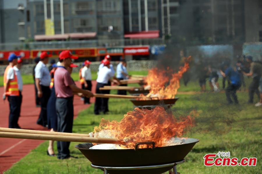 Police burn 40 kilograms of seized drugs in an event to mark the International Day Against Drug Abuse and Illicit Trafficking in Liuzhou City, South China’s Guangxi Zhuang Autonomous Region, June 26, 2018. Over 4,000 people participated the event. (Photo: China News Service/Zhu Liurong)