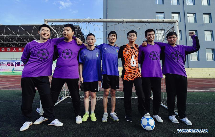 Some football players of the special education school of Changchun University pose for a group photo in Changchun, northeast China\'s Jilin Province, June 20, 2018. Sun Dongyuan and Fan Changjie, who were diagnosed with congenital eye disease, learn acupuncture and massage in the school. They are also players of the school\'s football team for visually impaired students. During the match, Sun and Fan identify position via a bell inside the ball and with guides\' instructions. The FIFA World Cup 2018 has become their popular topic since June 14, and they listen to the live broadcast and cheer for their favorite teams. (Xinhua/Xu Chang)