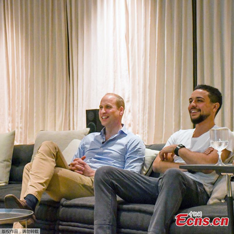 Britain\'s Prince William watches England’s World Cup match against Panama with the Crown Prince of Jordan while on a visit to the Middle East. Kensington Palace tweeted two pictures of the duke and the crown prince casually dressed and sitting side by side on a sofa watching the game on a large screen at the Beit Al Urdun Palace. (Photo/Agencies)