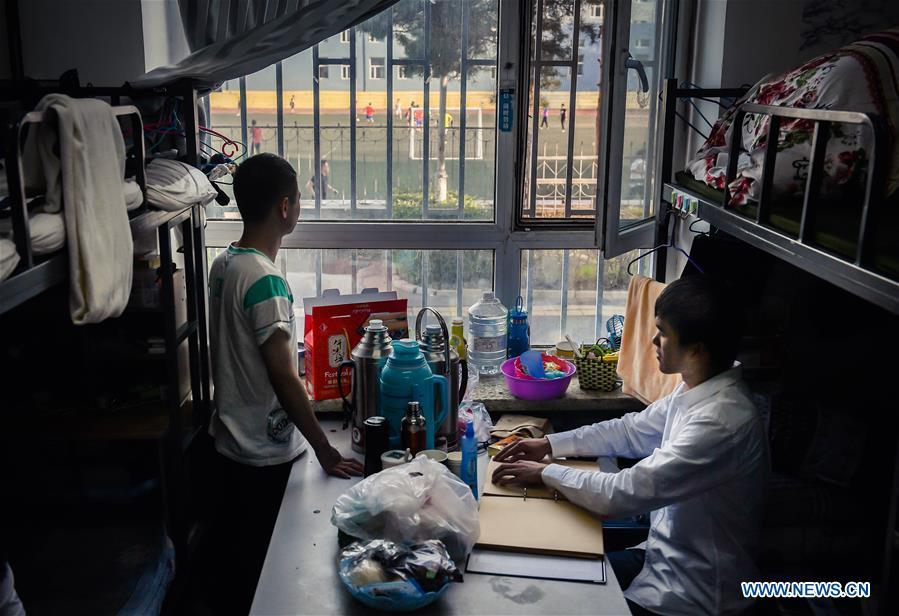 Sun Dongyuan (R) and Fan Changjie are seen in their dormitory at the special education school of Changchun University in northeast China\'s Jilin Province, June 20, 2018. Sun Dongyuan and Fan Changjie, who were diagnosed with congenital eye disease, learn acupuncture and massage in the school. They are also players of the school\'s football team for visually impaired students. During the match, Sun and Fan identify position via a bell inside the ball and with guides\' instructions. The FIFA World Cup 2018 has become their popular topic since June 14, and they listen to the live broadcast and cheer for their favorite teams. (Xinhua/Xu Chang)