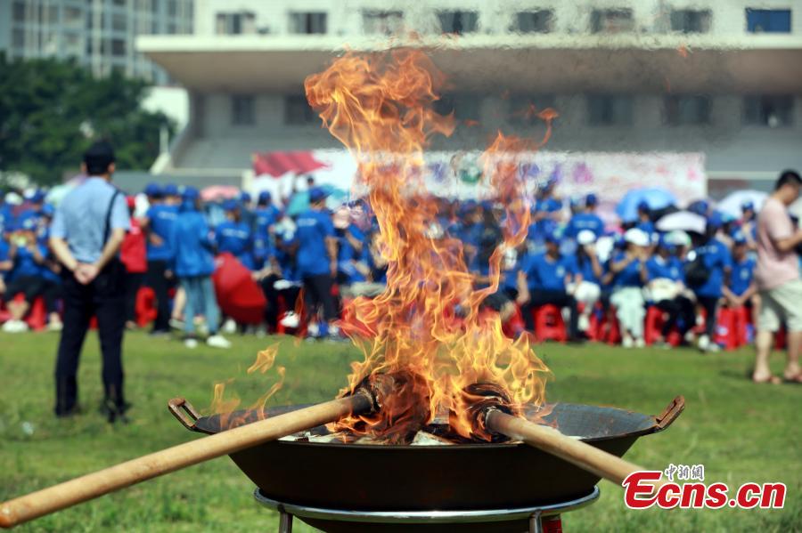 Police burn 40 kilograms of seized drugs in an event to mark the International Day Against Drug Abuse and Illicit Trafficking in Liuzhou City, South China’s Guangxi Zhuang Autonomous Region, June 26, 2018. Over 4,000 people participated the event. (Photo: China News Service/Zhu Liurong)