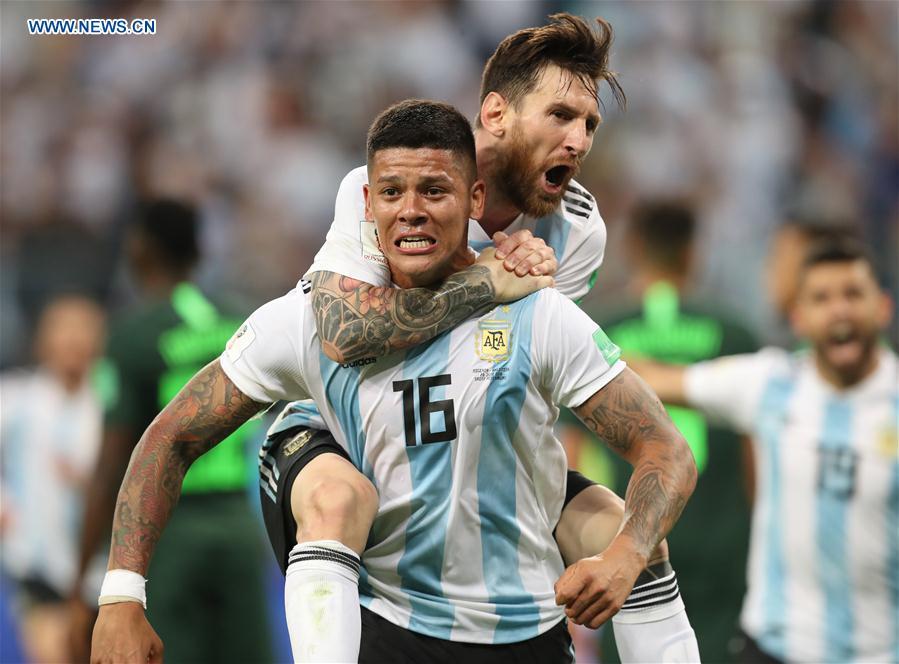 Argentina\'s Marcos Rojo (bottom) celebrates scoring with Lionel Messi during the 2018 FIFA World Cup Group D match between Nigeria and Argentina in Saint Petersburg, Russia, June 26, 2018. Argentina won 2-1 and advanced to the round of 16. (Xinhua/Yang Lei)
