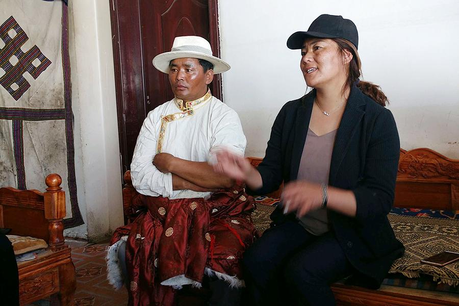 A relocated herdsman (left) lives in Caiqutang village at Damshung county, Lhasa, Tibet autonomous region, June 24, 2018. Before the herdsman moved to new home, his family\'s income from stocking yaks was 40,000 yuan per year. Because he suffers from rheumatism, his family was trapped in poverty. Now, the family is seeing better times after relocating. The man and his son work at the set\'s breeding farm, and also stock yaks at their own farm. The family\'s income has doubled. (Photo/chinadaily.com.cn)

Poverty relief

Caiqutang village, two kilometers from Yangbajing town, is a new relocation site that aims to ease life of poor herdsmen and herdswomen.

The village has rich geothermal resources. Currently, every villager\'s home has channels to transport hot spring water that can ease some villagers\' pain caused by rheumatism.