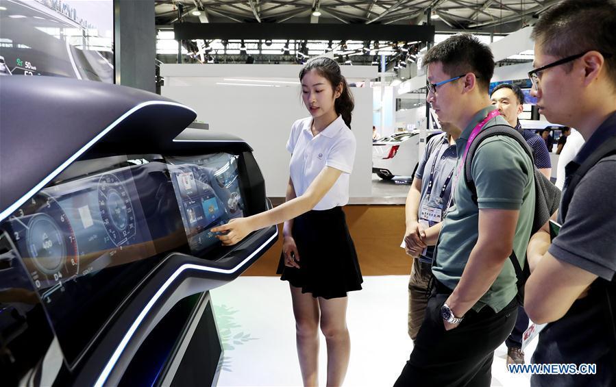 Visitors look at an interactive car dashboard that uses wireless network technologies during the Mobile World Conference Shanghai (MWCS) 2018 in east China\'s Shanghai, June 27, 2018. The three-day MWCS 2018 kicked off at the Shanghai New International Expo Center on Wednesday, showing trending mobile products, services and technologies. (Xinhua/Fang Zhe)