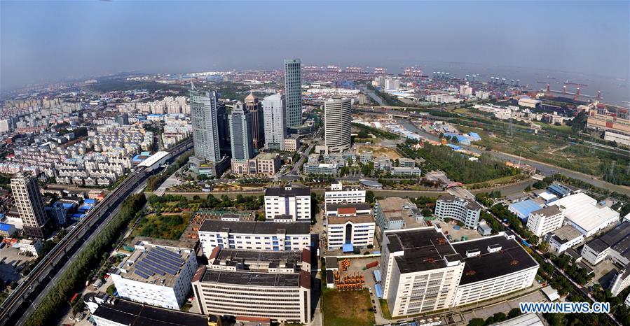 Aerial photo taken on Oct. 29, 2013 shows a scene of Waigaoqiao area in Shanghai free trade zone (FTZ) in Pudong of Shanghai, east China. China announced the opening-up and development of Pudong in 1990. Pudong is expecting to take the opportunity of celebrating the 40th anniversary of China\'s reform and opening-up to continue to spearhead the country\'s reform and development. (Xinhua/Fan Jun)