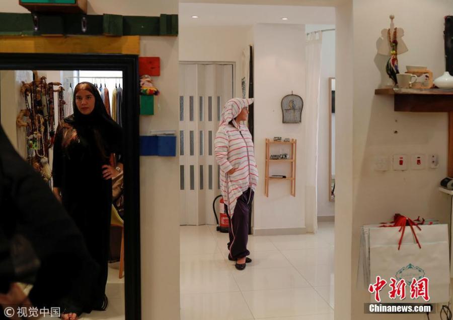 Eman Joharjy(R), a fashion designer, and her employee (L) pose in creations at her shop in Jeddah, Saudi Arabia, June 23, 2018. In 2007, frustrated by a lack of abayas made for running or cycling, Joharjy designed one for herself. She began making them for friends and selling what she dubbed the “sporty abaya”. (Photo/Agencies)