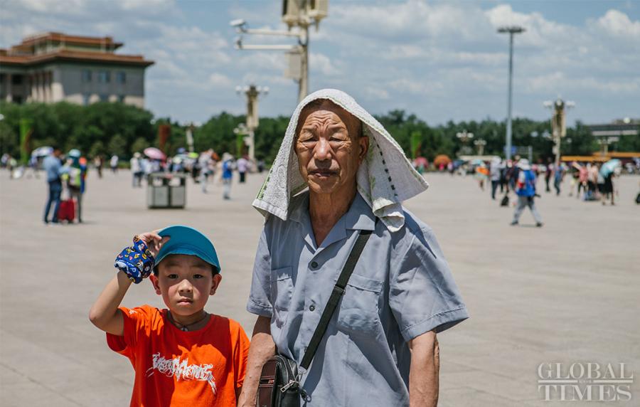An old man blocks the sun with a towel on his head in Beijing\'s Tiananmen Square on Thursday. (Photo: Li Hao/GT)