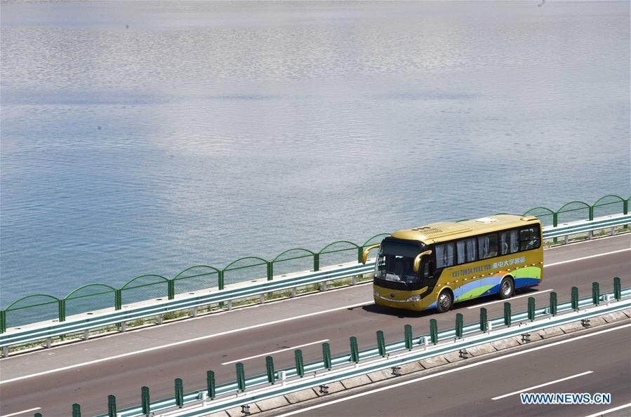 A vehicle runs by the Sayram Lake in northwest China\'s Xinjiang Uygur Autonomous Region, June 29, 2018. (Xinhua/Zhao Ge)