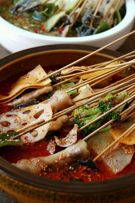 Boboji is cold skewers served in spicy broth. (Photo/Shine.cn)


Boboji

Though by name boboji is a chicken dish, it’s actually a spicy cold skewer snack featuring chicken, its offal and a variety of vegetables and meats. Originating in Leshan, boboji soaks a large amount of skewers in cold broth, often in large earthenware, hence the name bobo.

A true folk dish, boboji has a chicken broth-based stock, the oil in the dish comes from both the chicken and the chili oil. Ingredients like chicken heart, deboned chicken feet, black fungus, fried tofu and sausages are served together with the chicken in large bowls.

The unique aroma that separates boboji and other spicy snacks is the strong green peppercorn flavor from a green peppercorn infused oil seasoned with a lot of herbs and spices.

It has a very numbing yet refreshing feeling compared to the dried Sichuan peppercorns.