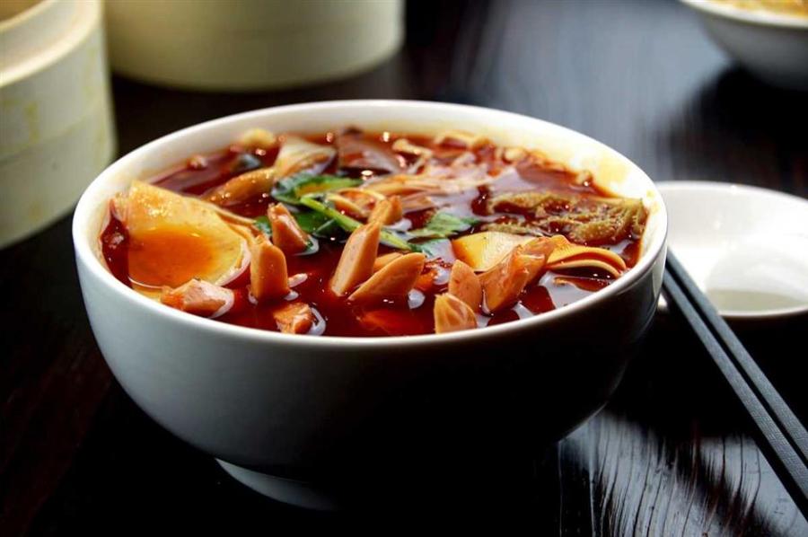 “Maocai is one man\'s hotpot, and hotpot is maocai for a group of people.” (Photo/Shine.cn)


Maocai

Maocai is the third Sichuan dish that took the country by storm after hotpot and malatang. There’s a popular saying that “maocai is one man’s hotpot, and hotpot is maocai for a group of people.”

Basically, maocai is a bowl of spicy vegetable and meat stew, and it’s much simpler than hotpot and even malatang — you don’t have to pick the ingredients from the shelves or cook them in the broth yourself, the restaurant will do all the work.

The character mao here is a verb that means cooking the ingredients. The ingredients are first boiled in a spicy broth and a bowl on the side already has different seasonings in place. Once cooked, the meats and vegetables are poured into the bowl along with a large spoonful of spicy broth. Top the bowl with cilantro, scallion and Sichuan-style fermented bean paste and the dish is ready to serve.

Maocai can be eaten with a bowl of rice as a dish or alone as a meal. Another difference that sets maocai and hotpot or chuanchuanxiang apart is that the broth is edible as it contains much less oil.

Popular ingredients in maocai include duck intestine, beef tripe, beencurd sheets, tofu, bok choy and duck blood tofu. If you don’t want to order every ingredient, most of the maocai shops offer combo meals that include a little bit of everything.