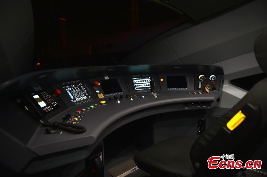 Inside a driver’s cabin on a new Fuxing train in Daxing District, Beijing. With a designed speed of 350 kilometers per hour, the new train is 414.26 meters long with 16 carriages, twice as many as the current Fuxing. It has 1,193 seats.  (Photo: China News Service/Zhai Lu)