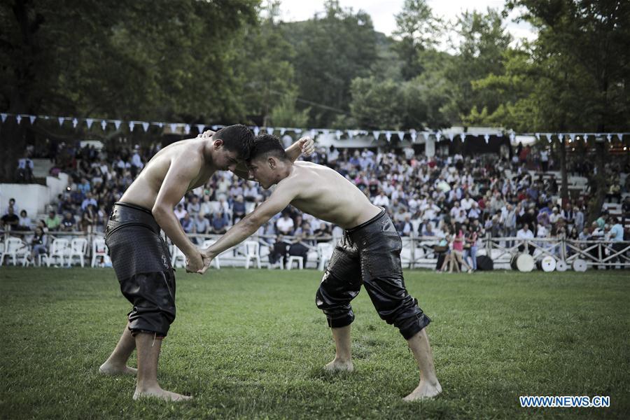 Photo taken on June 30, 2018, shows wrestlers participate in traditional oil wrestling competition in the village of Sohos, Thessaloniki, Greece. (Xinhua/ Dimitris Tosidis)