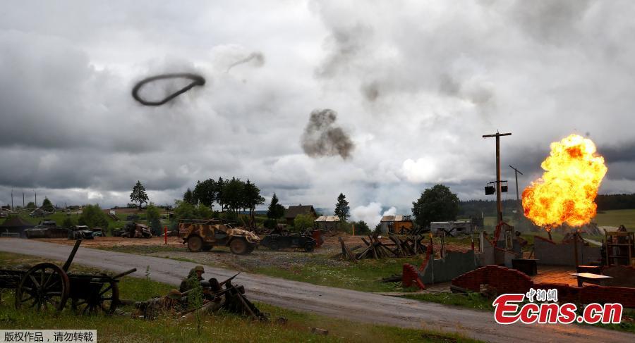 Military enthusiasts take part in a re-enactment of a World War II battle on the eve of Independence Day at the \