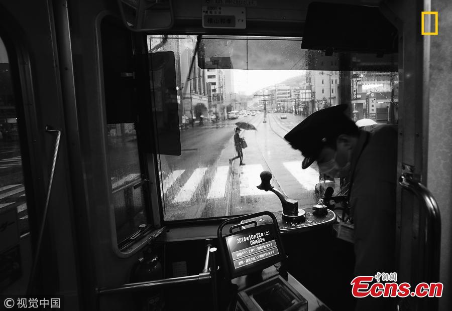 “Another Rainy Day in Nagasaki, Japan” by Hiro Kurashina. This is a view of the main street from a tram in Nagasaki on a rainy day. The tram is vintage and yet retrofitted with modern ticketing equipment. No conductor is on board any more - only the driver. (Photo/VCG)