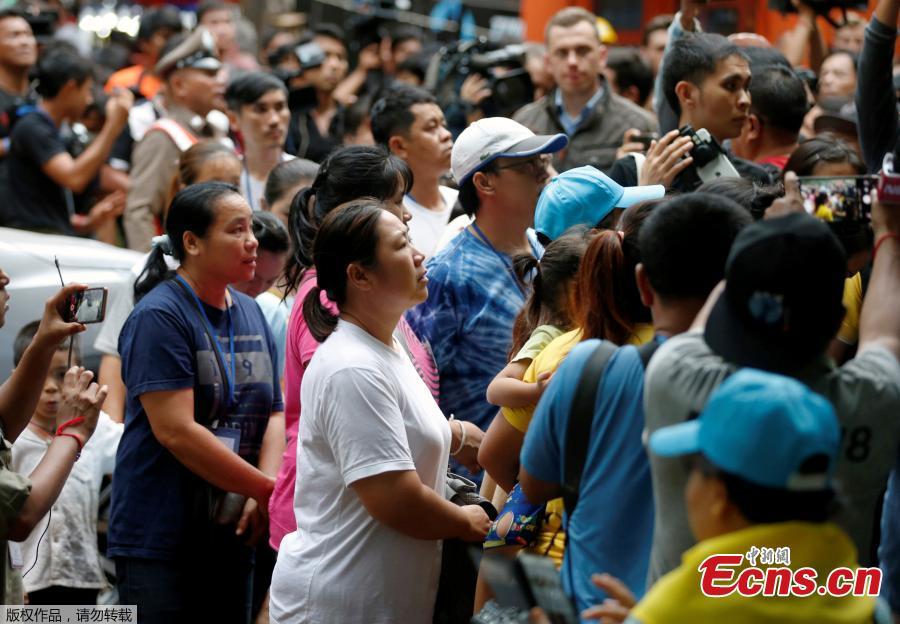 Family members are escorted by police on their way to enter the Tham Luang cave complex, as members of an under-16 soccer team and their coach have been found alive according to local media, in the northern province of Chiang Rai, Thailand, July 4, 2018. (Photo/Agencies)