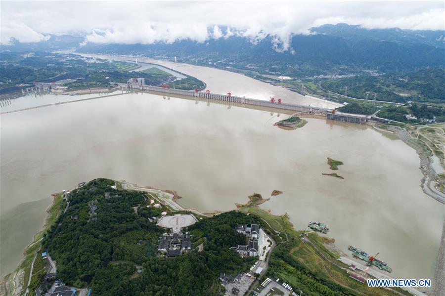 Photo taken on July 5, 2018 shows the Three Gorges Dam and nearby area in central China\'s Hubei Province. At 8 a.m. of July 5, the reservoir faced an inflow of 51,000 cubic meters per second and an outflow of 40,000 cubic meters per second. The first flood of the Yangtze River this year has formed on its upper reaches. (Xinhua/Wang Gang)