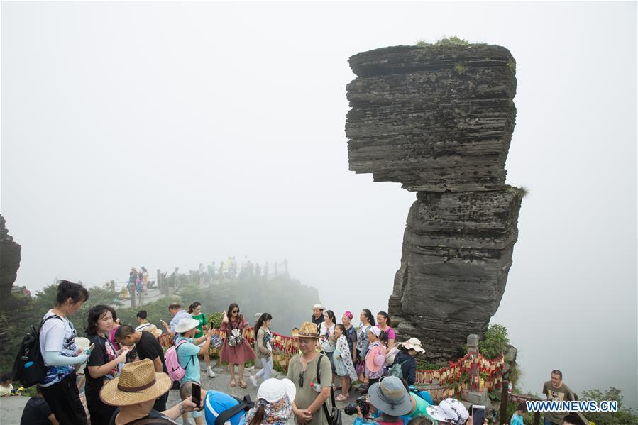 Tourists go sightseeing at the Mount Fanjingshan scenic spot in Tongren City, southwest China\'s Guizhou Province, Aug. 7, 2017. Mount Fanjingshan was inscribed on the World Heritage List on July 2, 2018 at the 42nd World Heritage Committee meeting in Bahrain. The ecosystem of Fanjingshan has preserved large numbers of ancient relict plants, rare and endangered creatures, as well as unique species. (Xinhua/Yao Lei)