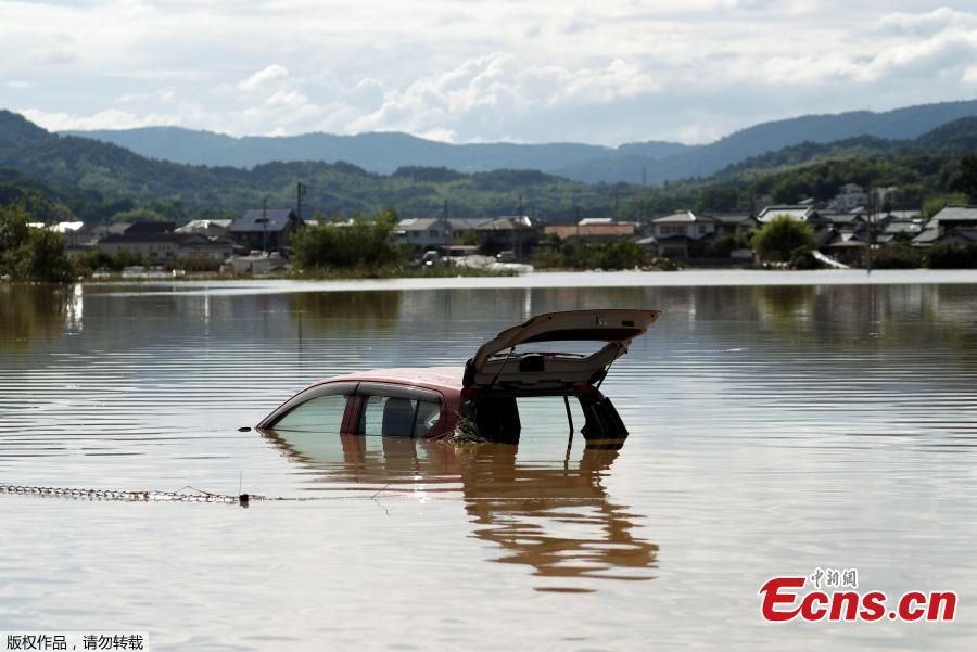 A car is submerged at a flooded area in Mabi town in Kurashiki, Okayama Prefecture, Japan, July 8, 2018. The death toll from torrential rain and landslides in western Japan rose to 88 people early on Monday, with dozens still missing after the rescue of more than 2,000 stranded in the city of Kurashiki.(Photo/Agencies)