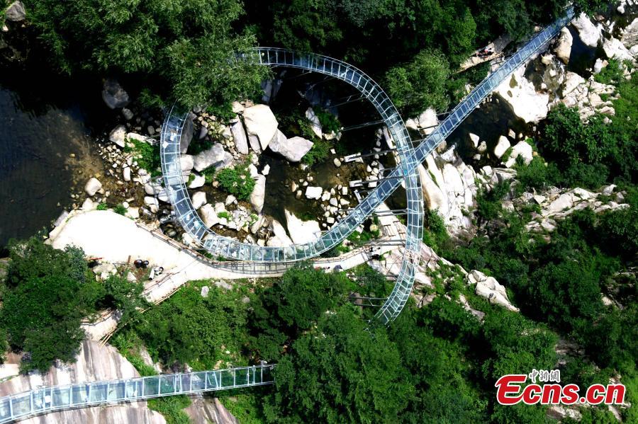 An aerial view of a waterslide over the Xiangma River in Lushan County, Central China’s Henan Province, July 9, 2018. The 2.3-kilometer-long waterside under construction around a mountain slope and cliff has a vertical drop of 100 meters, earning it the title of the longest and most challenging waterslide in central China. (Photo: China News Service/Dong Fei)