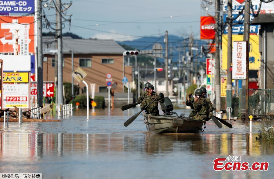 Japan Self-Defense Force soldiers ride a boat during their rescue work at a flooded area in Mabi town in Kurashiki, Okayama Prefecture, Japan, July 8, 2018. The death toll from torrential rain and landslides in western Japan rose to 88 people early on Monday, with dozens still missing after the rescue of more than 2,000 stranded in the city of Kurashiki.(Photo/Agencies)