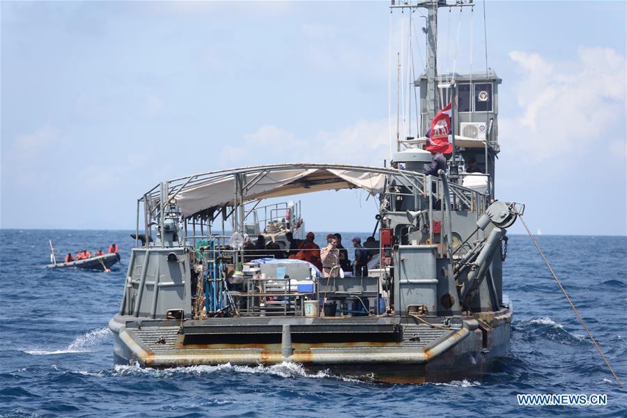 A Thai navy vessel searches for missing passengers from the capsized boat in the accident area in Phuket, Thailand, July 8, 2018. At least 42 people were confirmed dead and 14 others still missing after two boats capsized in a storm off southern Thailand\'s Phuket island, Thai officials said on Saturday. (Xinhua/Qin Qing)