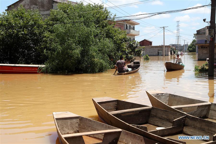 Residents take boat in flooded area in Qiaoxi Village of Maxu Township of Fuzhou City, east China\'s Jiangxi Province, July 8, 2018. Flood caused by heavy rain damaged crops and housings in Maxu Township and rescue groups were set up to help the affected people. (Xinhua/He Jianghua)