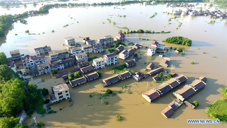 Aerial photo taken on July 8, 2018 shows the flooded area in Qiaoxi Village of Maxu Township of Fuzhou City, east China\'s Jiangxi Province. Flood caused by heavy rain damaged crops and housings in Maxu Township and rescue groups were set up to help the affected people. (Xinhua/He Jianghua)