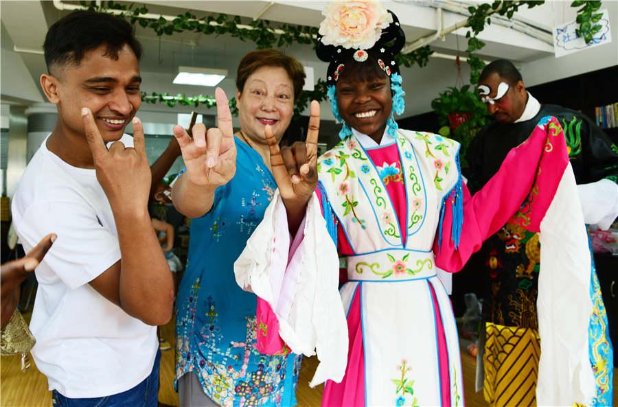 A teacher guides foreign students to learn movement from Peking Opera in Zhenjiang city, Jiangsu Province, on July 9, 2018. (Photo/Asianewsphoto)

Foreign students from Jiangsu University visited a Peking Opera school in Zhenjiang city, Jiangsu Province to experience Peking Opera culture. The students from Pakistan, Nigeria, Tanzania, Bangladesh, Ghana and India painted Peking Opera masks with children, learned singing skills, and learned about Chinese Peking Opera art.